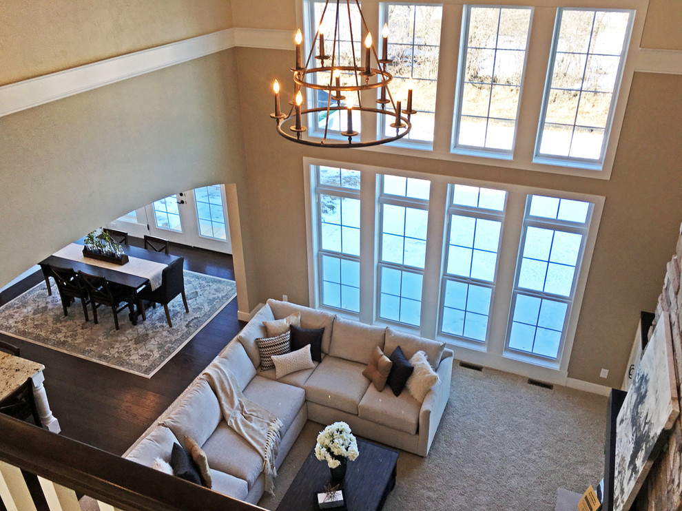 Photo of a large classic formal open plan living room in Other with beige walls, carpet, a standard fireplace, a stone fireplace surround and no tv.