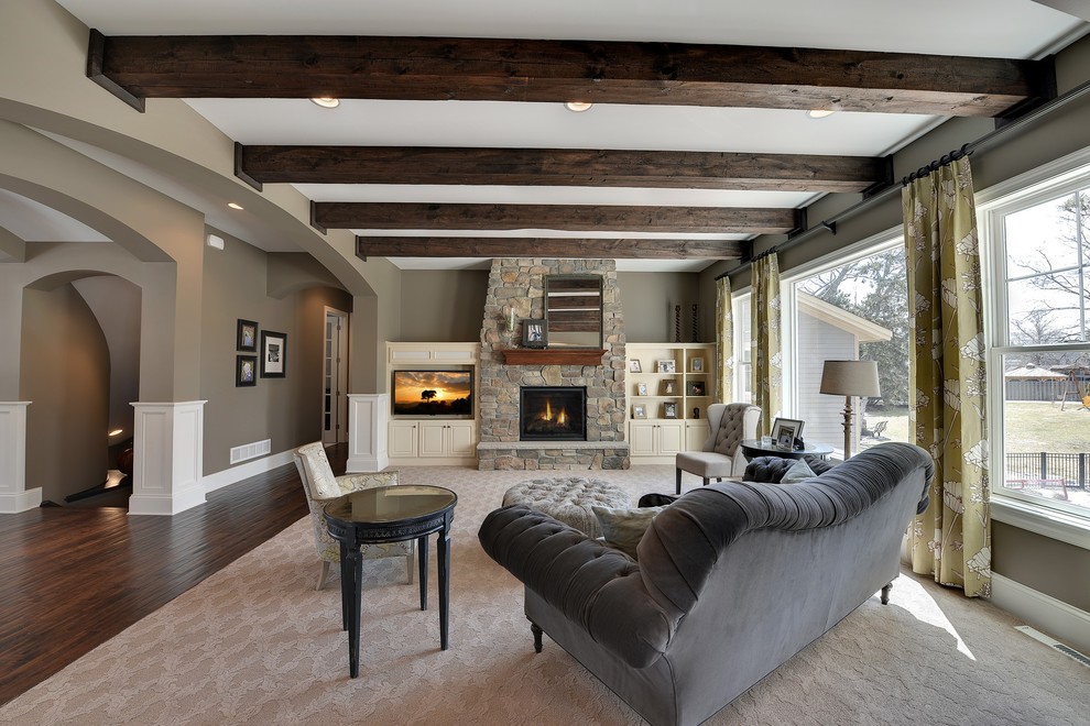This is an example of a large classic grey and cream living room in Minneapolis with brown walls, a standard fireplace, a stone fireplace surround, a built-in media unit and feature lighting.