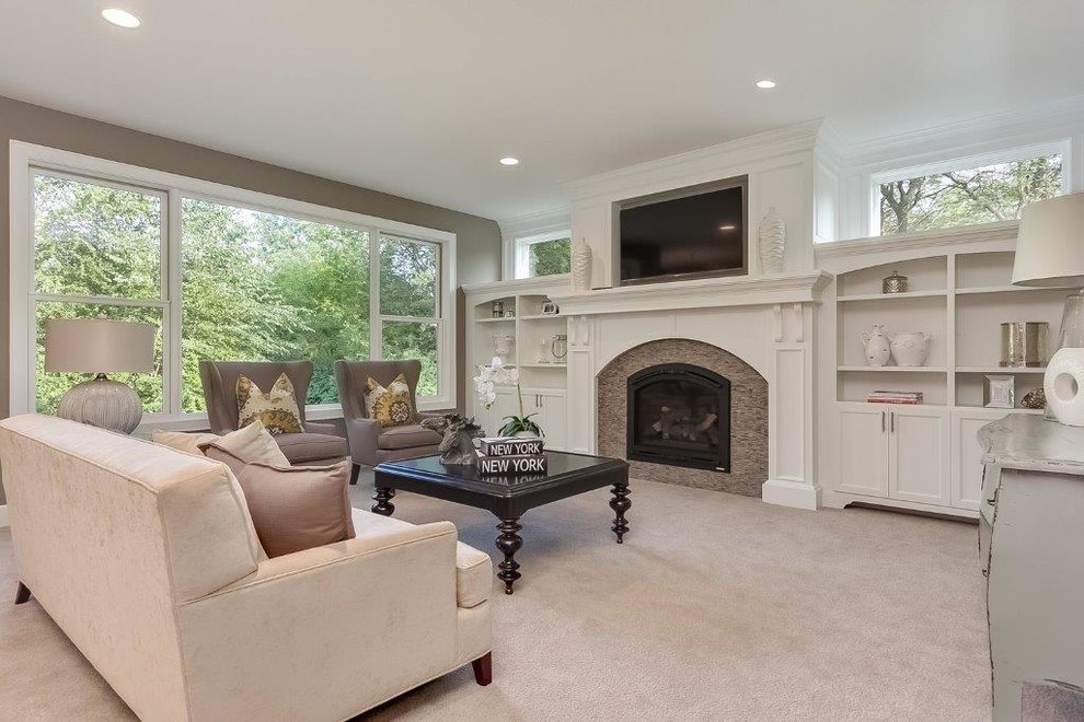 Example of a transitional carpeted living room design in Minneapolis with gray walls and a standard fireplace