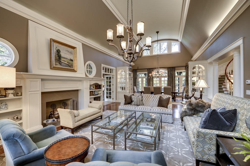 Elegant open concept living room photo in Minneapolis with brown walls, a standard fireplace and no tv