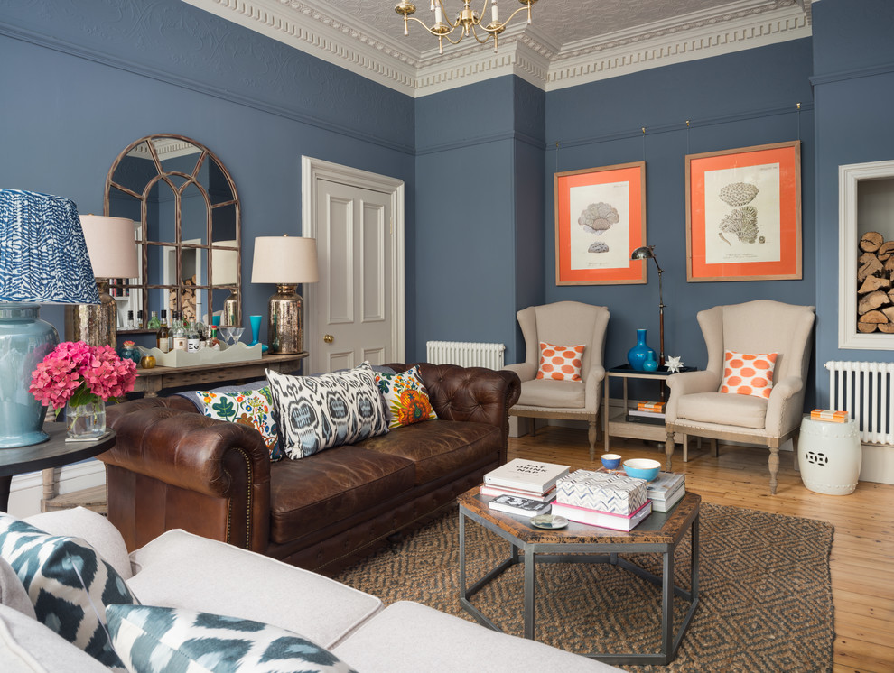 Medium sized classic enclosed living room in Edinburgh with blue walls, light hardwood flooring, beige floors and feature lighting.