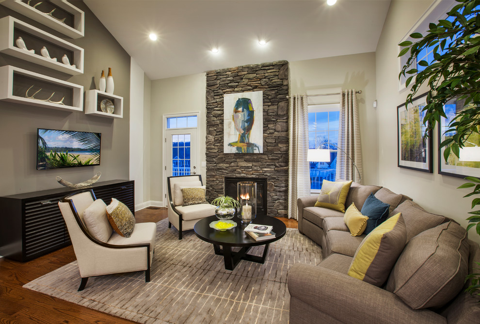 This is an example of a traditional formal living room in Denver with a stone fireplace surround, beige walls, dark hardwood flooring, a standard fireplace and a wall mounted tv.