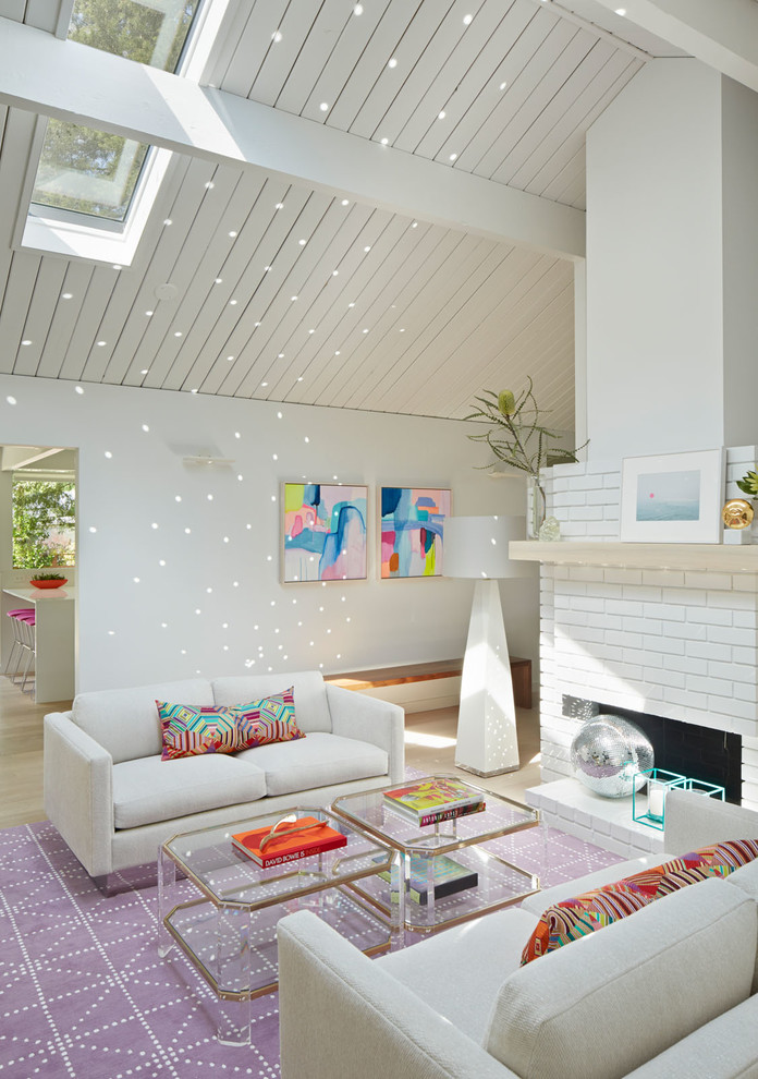 Example of a mid-century modern formal medium tone wood floor living room design in San Francisco with white walls, a standard fireplace and a brick fireplace