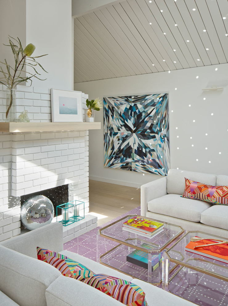 1960s formal light wood floor living room photo in San Francisco with white walls, a standard fireplace and a brick fireplace