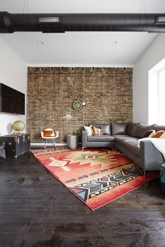 Example of a mid-sized southwest open concept dark wood floor living room design in Chicago with yellow walls, no fireplace and a wall-mounted tv
