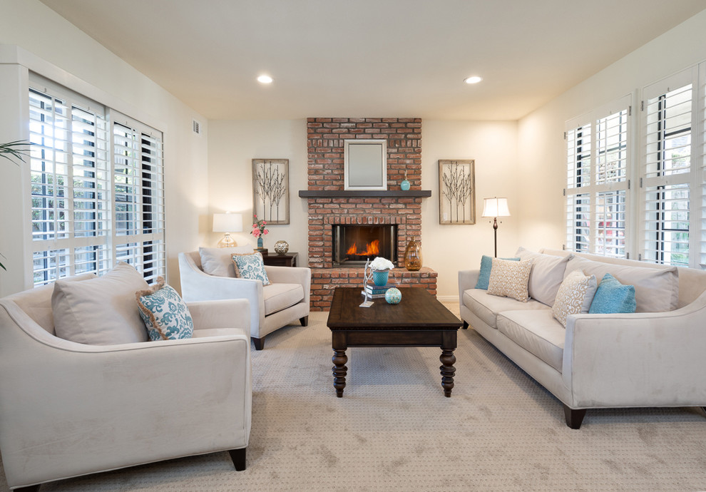 Small transitional formal and enclosed carpeted and beige floor living room photo in Los Angeles with white walls, a standard fireplace, a brick fireplace and no tv
