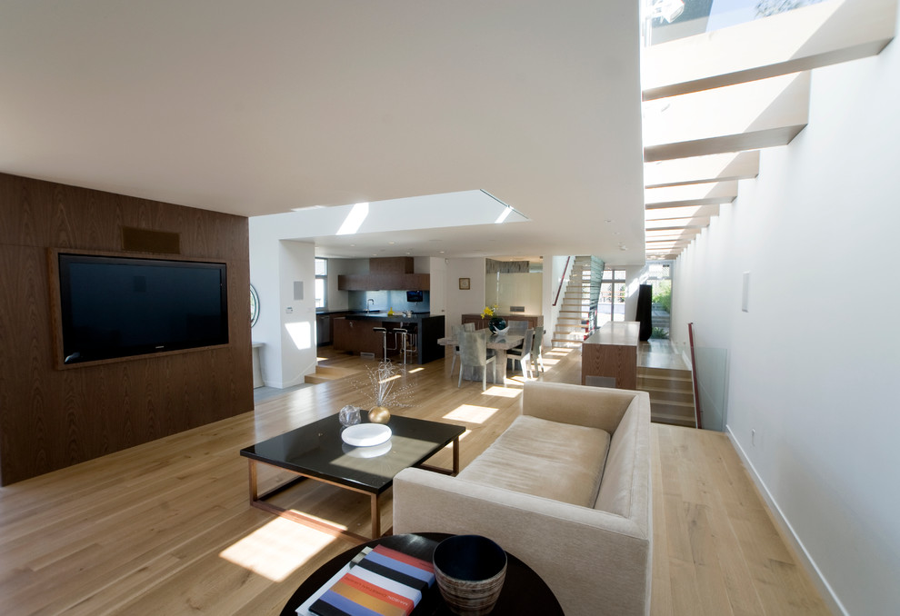 Trendy open concept living room photo in Los Angeles with white walls and a wall-mounted tv