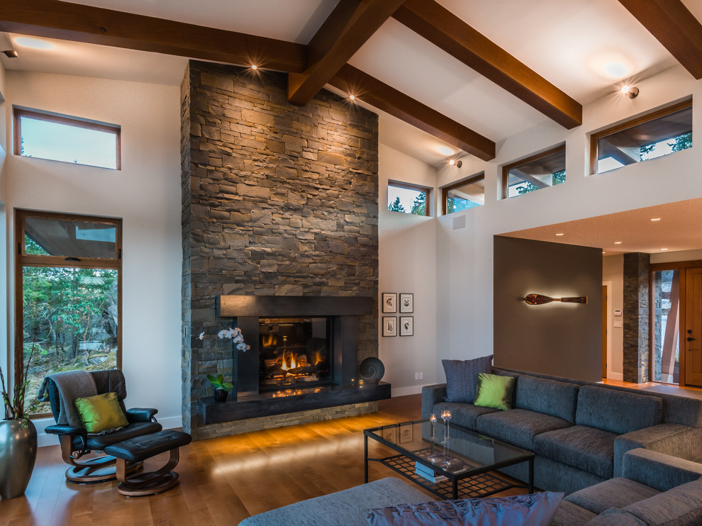 Design ideas for a contemporary living room in Vancouver with white walls, a standard fireplace and a stone fireplace surround.