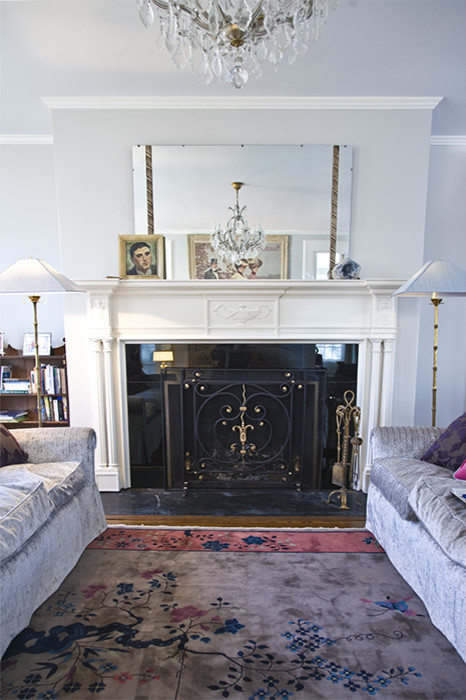 Photo of a large bohemian formal enclosed living room in New York with grey walls, dark hardwood flooring, a standard fireplace and a wooden fireplace surround.