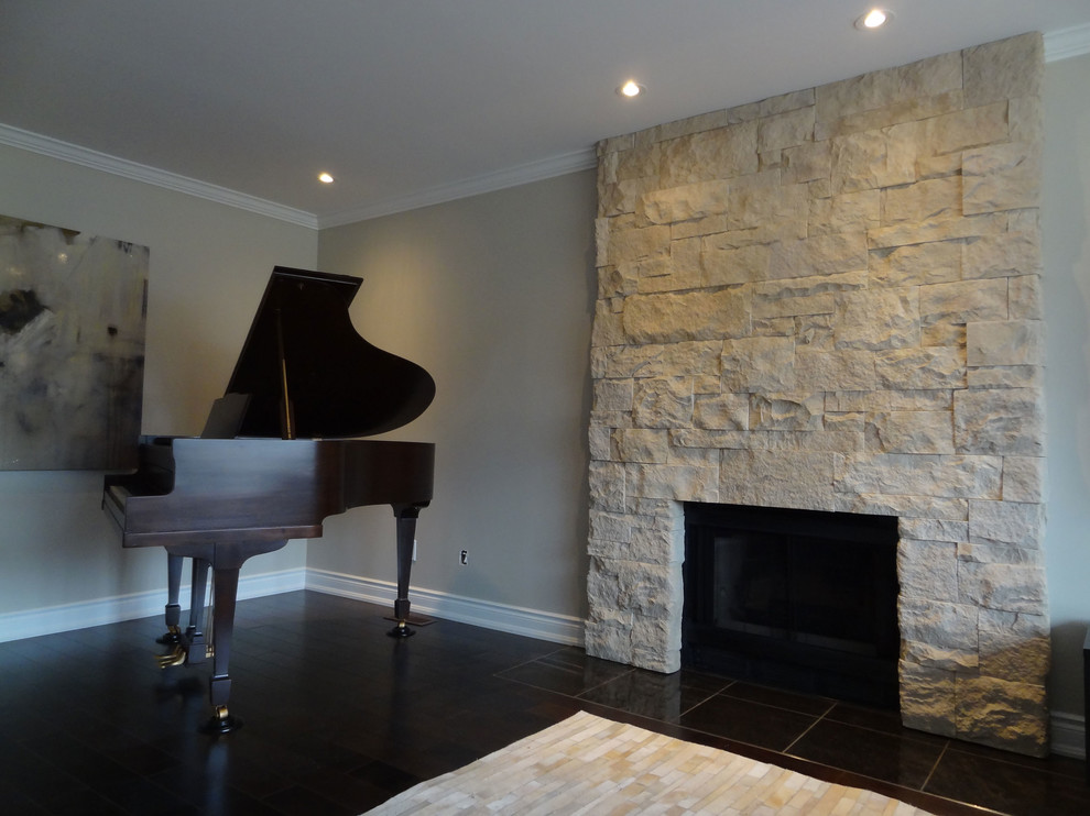 Living room - mid-sized contemporary enclosed dark wood floor living room idea in Toronto with a music area, gray walls, a standard fireplace and a stone fireplace