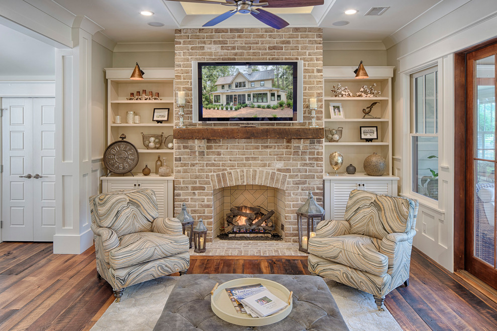 Inspiration for a medium sized farmhouse open plan living room in Grand Rapids with white walls, dark hardwood flooring, a standard fireplace, a brick fireplace surround and a wall mounted tv.