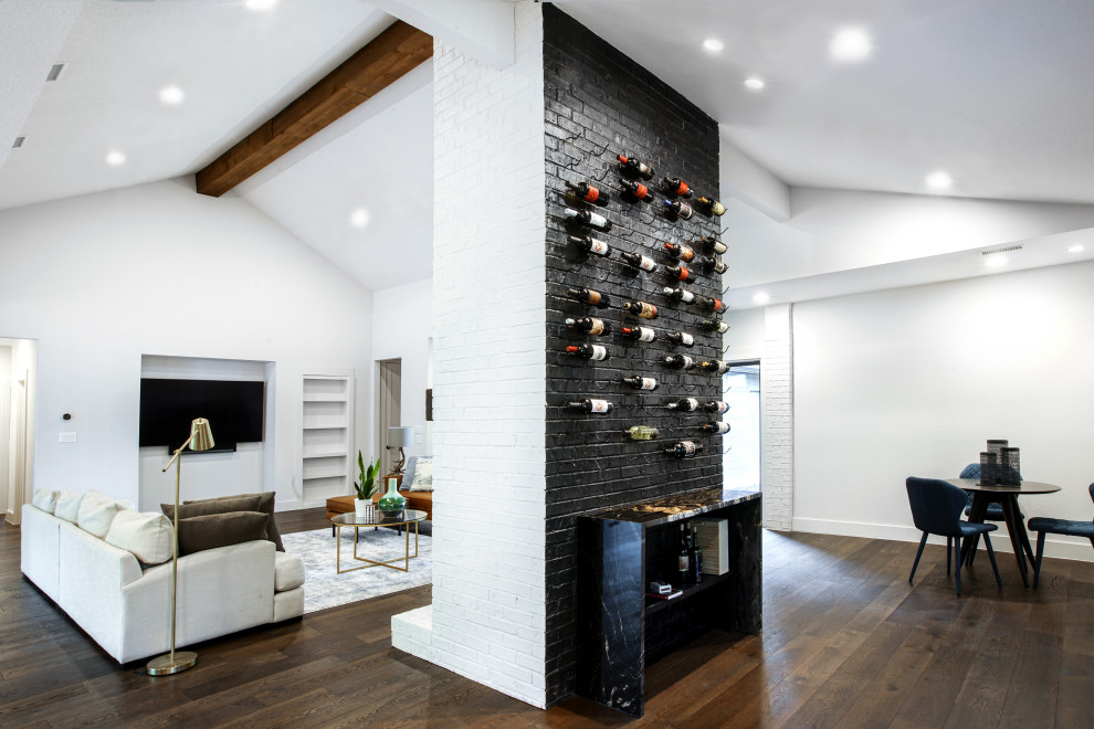 Example of a large 1950s open concept dark wood floor, brown floor, vaulted ceiling and brick wall living room design in Dallas with a bar, white walls, a standard fireplace, a brick fireplace and a media wall