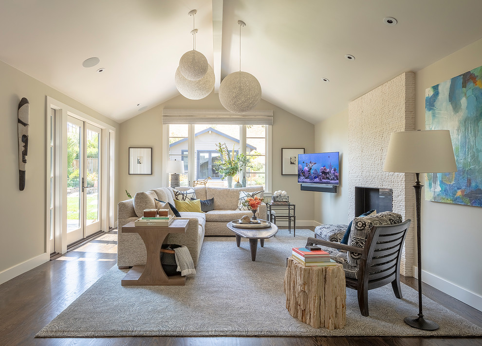 Ejemplo de salón actual con paredes beige, suelo de madera oscura, todas las chimeneas y suelo marrón
