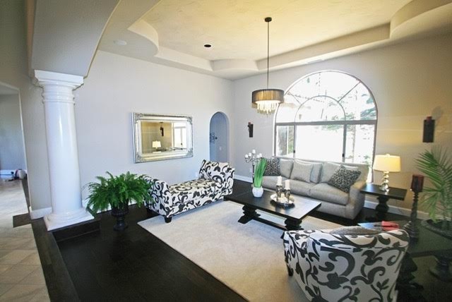 This is an example of a contemporary living room in San Diego with grey walls, dark hardwood flooring and no tv.