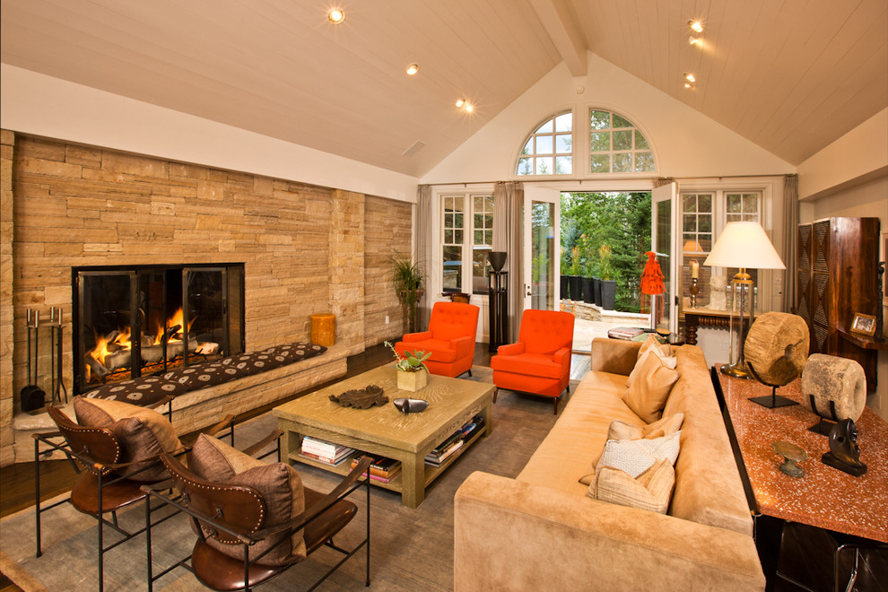 Contemporary living room in Denver with white walls and a stone fireplace surround.