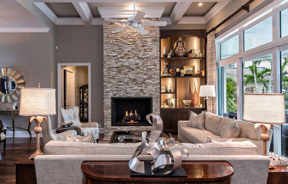 Inspiration for a large contemporary formal open plan living room in Miami with grey walls, dark hardwood flooring, a standard fireplace, a stone fireplace surround and no tv.