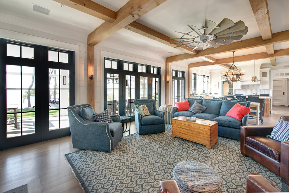 Inspiration for a large coastal open concept medium tone wood floor and brown floor living room remodel in Baltimore with gray walls, a standard fireplace, a brick fireplace and no tv