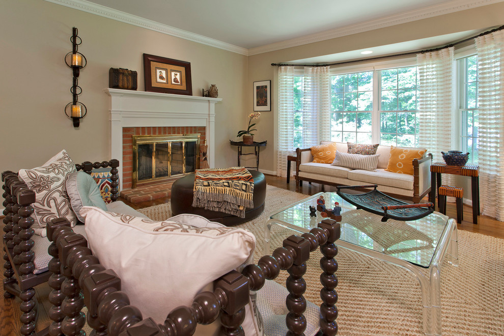 Photo of a medium sized contemporary formal open plan living room in Baltimore with medium hardwood flooring, a two-sided fireplace, a brick fireplace surround, no tv, grey walls and brown floors.