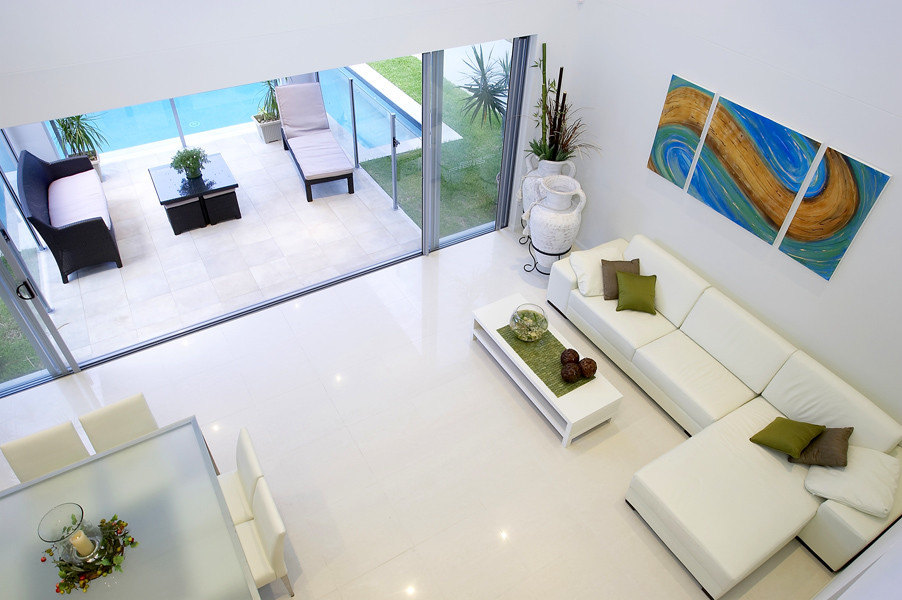 Photo of an expansive contemporary formal open plan living room in Brisbane with white walls, white floors, ceramic flooring, a ribbon fireplace and no tv.