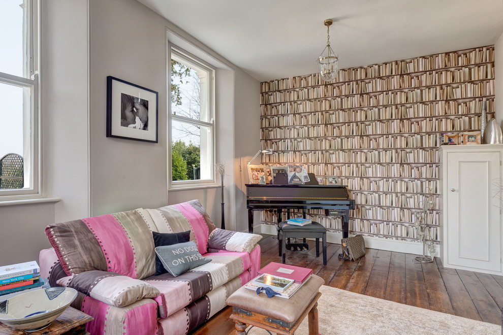 Example of a mid-sized transitional medium tone wood floor living room design in Devon with a music area and gray walls