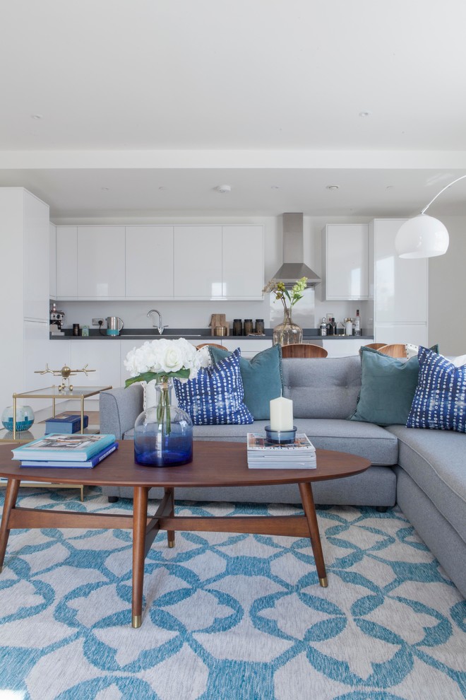 Inspiration for a contemporary grey and teal open plan living room in London.