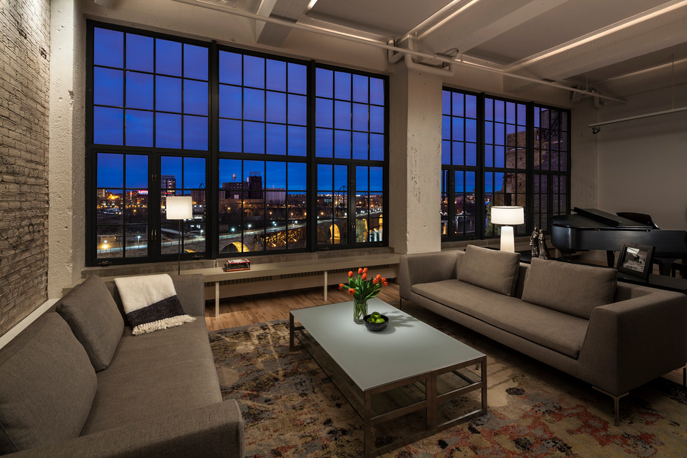 Living room - large industrial loft-style light wood floor living room idea in Minneapolis
