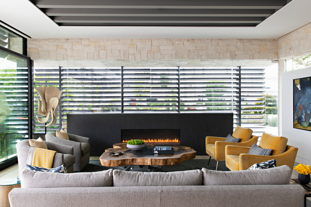 Large trendy beige floor living room photo in Orange County with beige walls, a ribbon fireplace and no tv