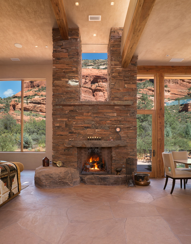Пример оригинального дизайна: гостиная комната в стиле фьюжн с бежевыми стенами, стандартным камином и фасадом камина из камня