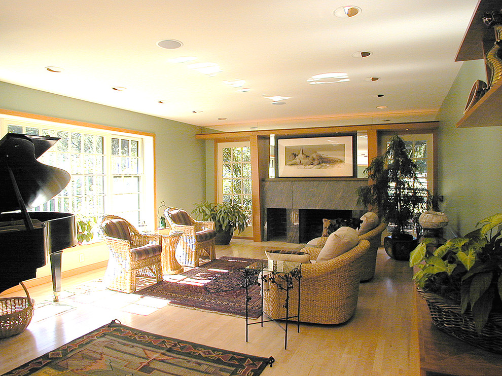 Example of a mid-sized transitional open concept and formal light wood floor living room design in Portland with a concealed tv, green walls, a standard fireplace and a stone fireplace