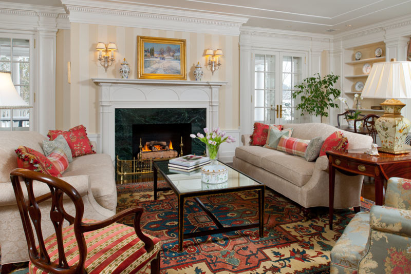 This is an example of a large classic formal enclosed living room in Other with medium hardwood flooring, a standard fireplace, multi-coloured walls and a tiled fireplace surround.