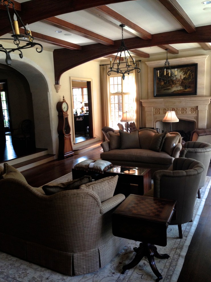 Design ideas for a large traditional open plan living room in Dallas with beige walls, dark hardwood flooring, a stone fireplace surround and a concealed tv.