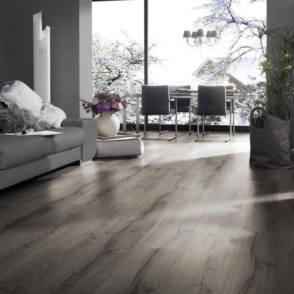 Example of a minimalist laminate floor and gray floor living room design in Other with gray walls