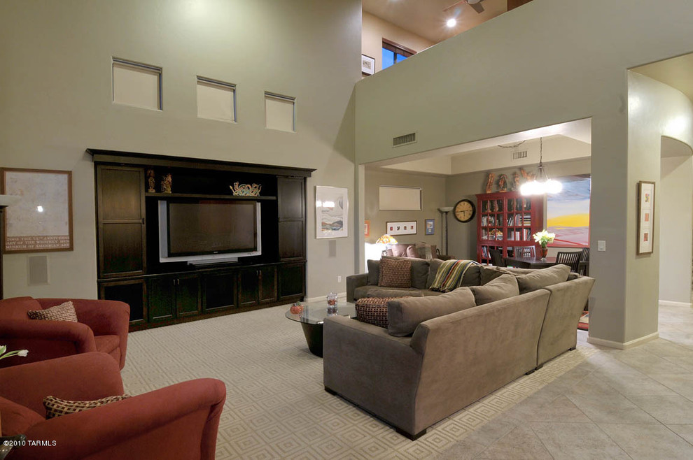 Example of a large trendy loft-style porcelain tile living room design in Phoenix with green walls, no fireplace and a media wall