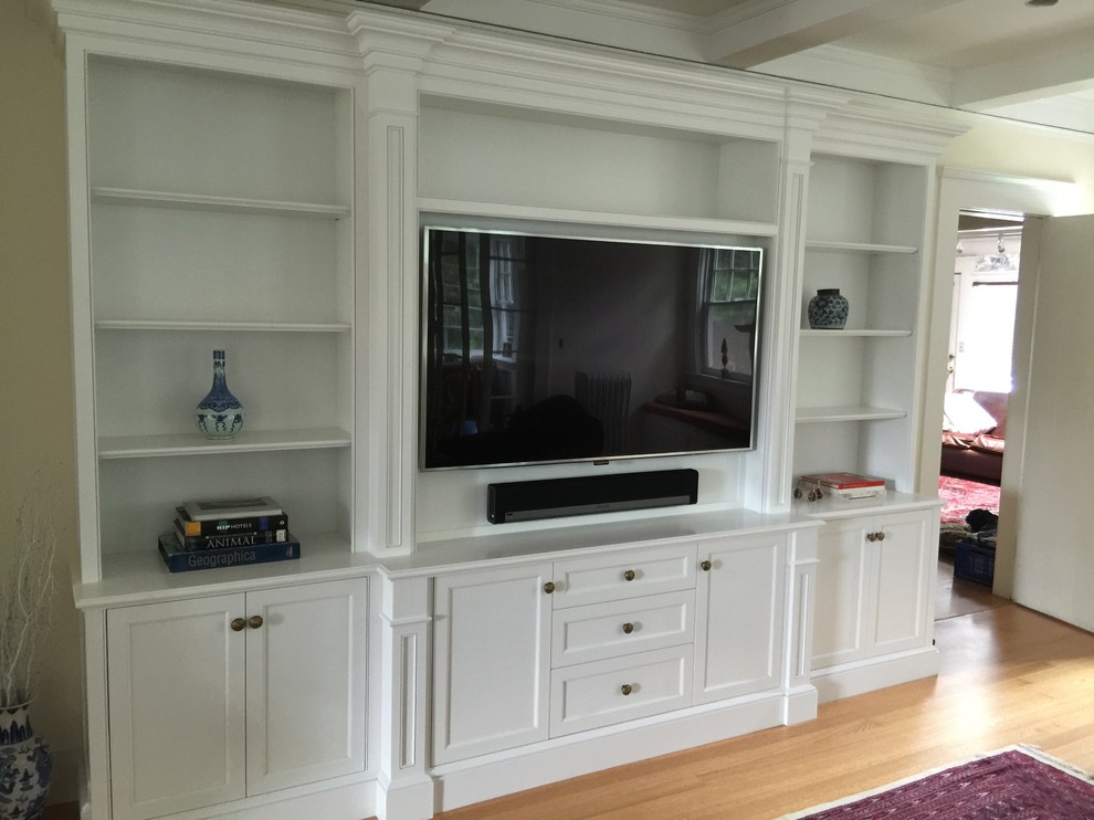 Medium sized classic formal enclosed living room in New York with beige walls and a wall mounted tv.