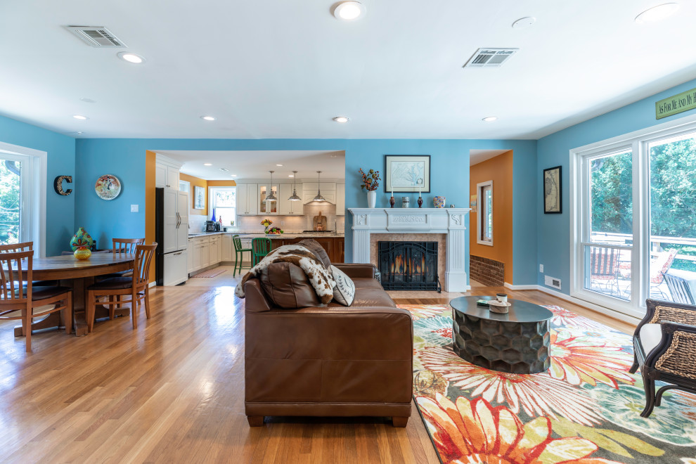 Photo of a large contemporary open plan living room in DC Metro with white floors, blue walls, medium hardwood flooring and a standard fireplace.