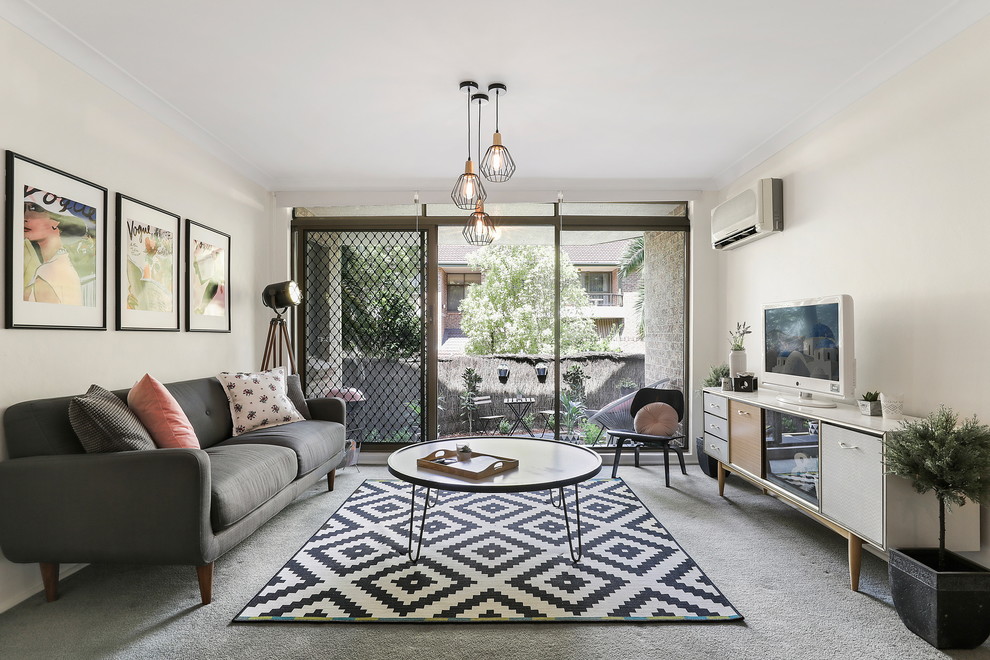 Mid-sized 1960s formal and enclosed carpeted and gray floor living room photo in Sydney with white walls and a tv stand