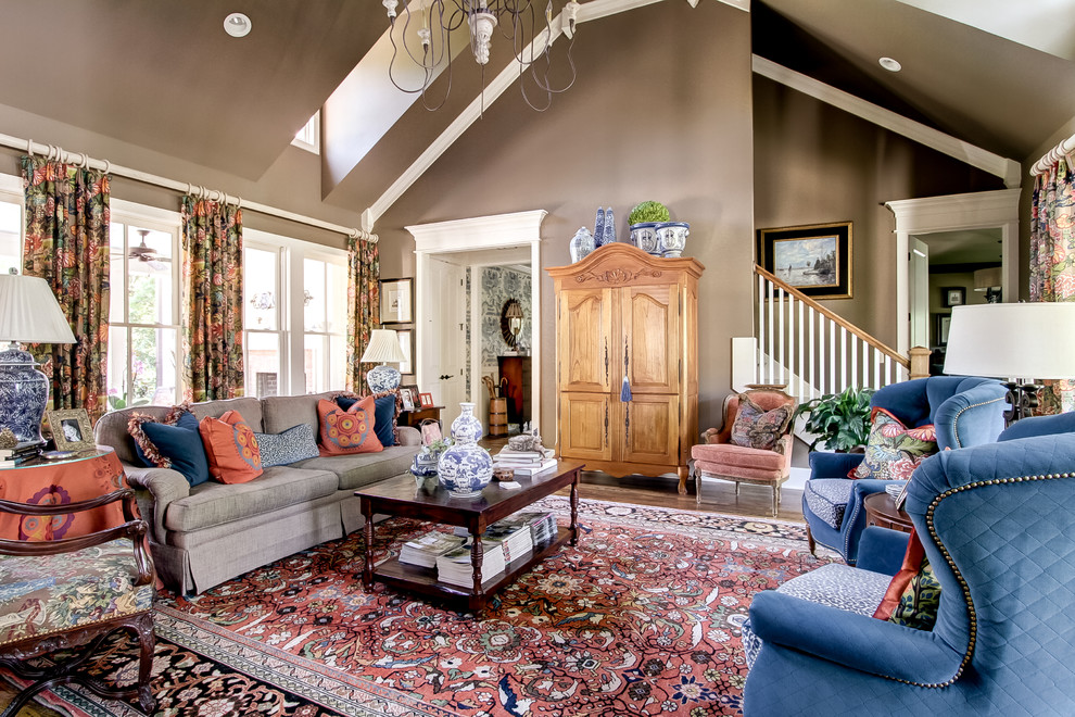 Example of a large classic open concept medium tone wood floor living room design in Nashville with brown walls