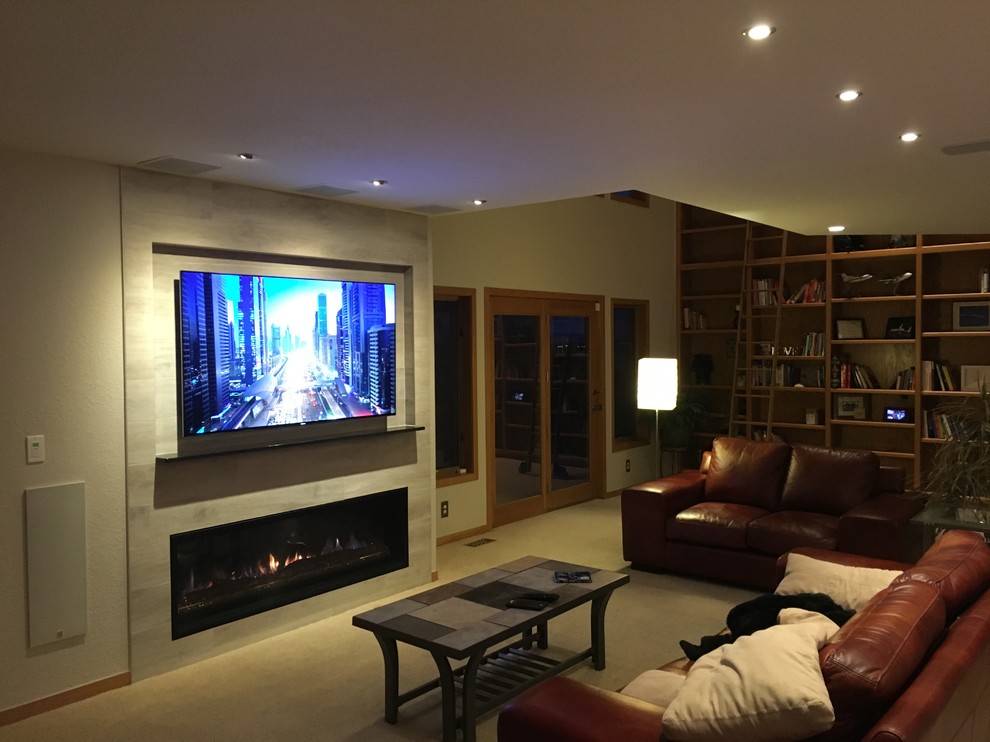 Exempel på ett mellanstort modernt allrum med öppen planlösning, med ett musikrum, grå väggar, heltäckningsmatta, en spiselkrans i trä, en väggmonterad TV och en bred öppen spis