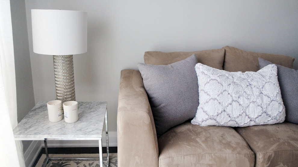 Medium sized contemporary formal enclosed living room in Toronto with beige walls and medium hardwood flooring.