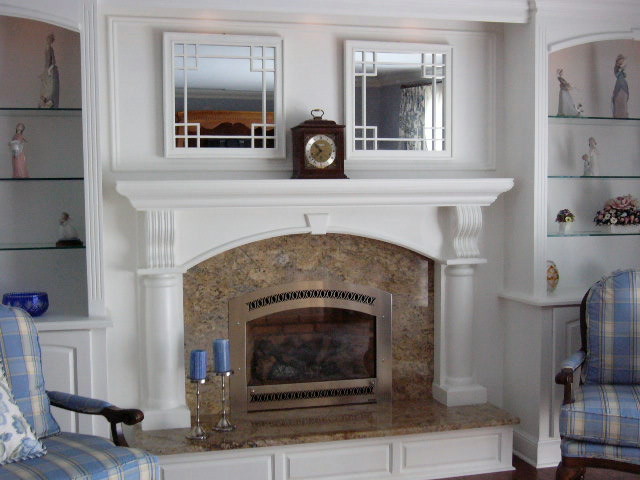 This is an example of a medium sized traditional living room in Philadelphia with dark hardwood flooring, a standard fireplace and a stone fireplace surround.
