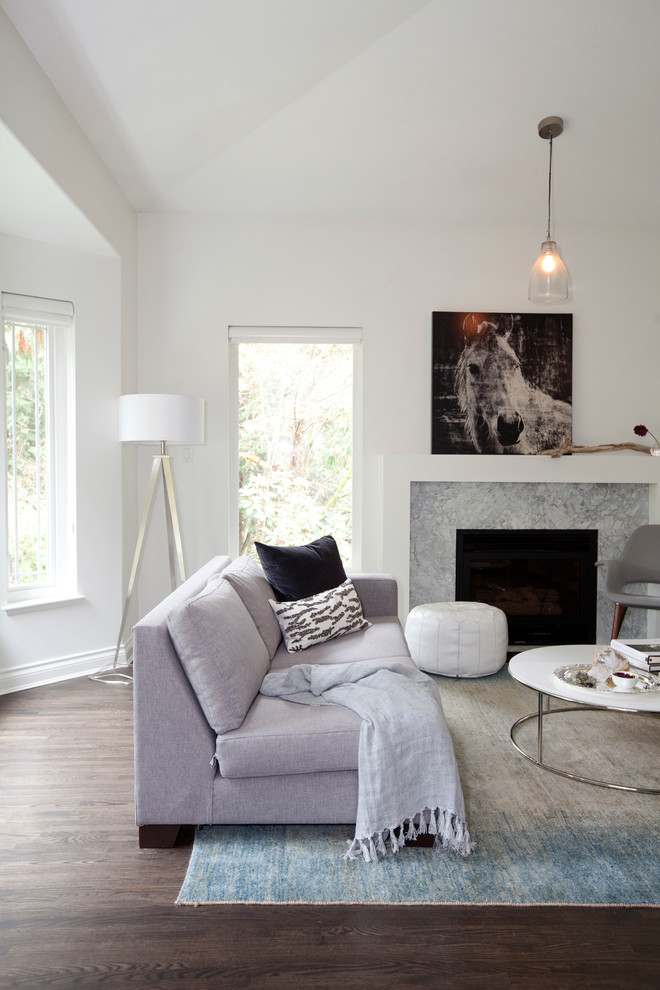 Traditional living room in Vancouver with white walls, dark hardwood flooring and a standard fireplace.