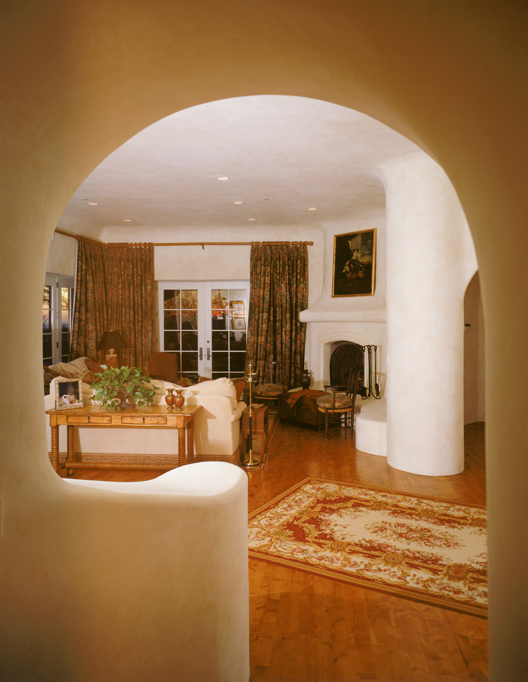 Esempio di un ampio soggiorno stile americano aperto con libreria, pareti beige, pavimento con piastrelle in ceramica, camino classico, cornice del camino in mattoni e parete attrezzata