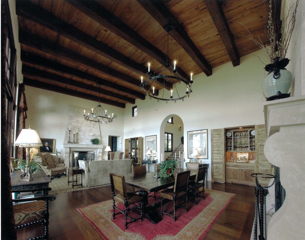 Mediterranean open plan living room in Atlanta with dark hardwood flooring.