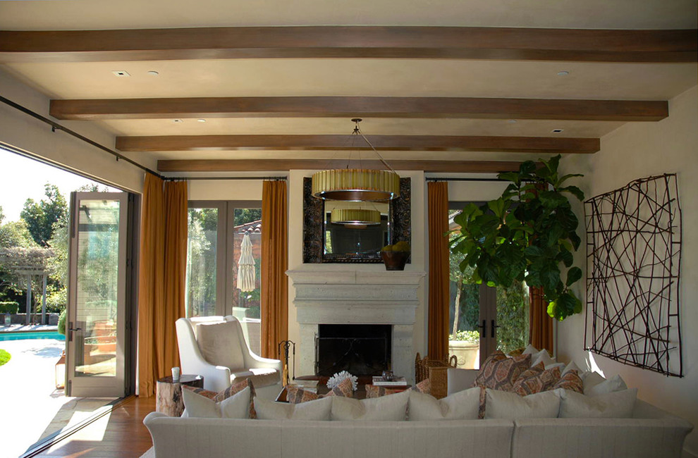 Example of a transitional living room design in San Francisco with a standard fireplace