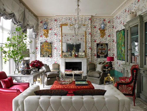 Maximalism art with bold floral patterned wallpaper and a densely furnished living room