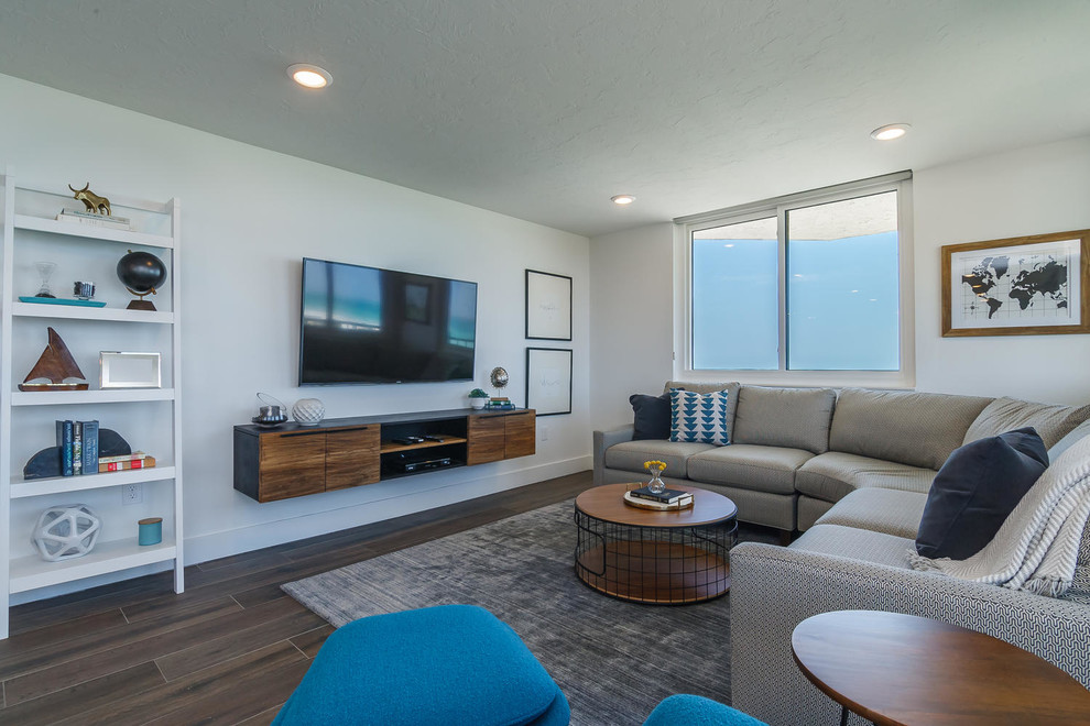 Beach style dark wood floor living room photo in Tampa with white walls and a wall-mounted tv