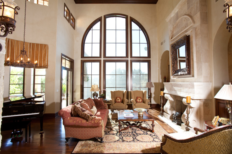 Large tuscan formal and open concept dark wood floor living room photo in Austin with beige walls, a standard fireplace and a stone fireplace