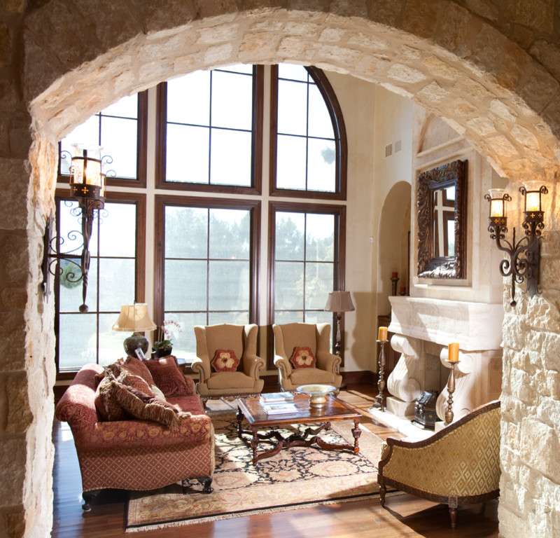 Large tuscan formal and open concept dark wood floor living room photo in Austin with beige walls, a standard fireplace and a stone fireplace