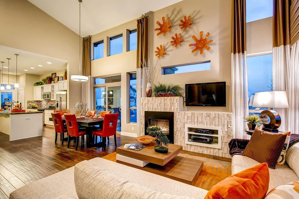 Contemporary open plan living room in Denver with beige walls, a standard fireplace and a wall mounted tv.