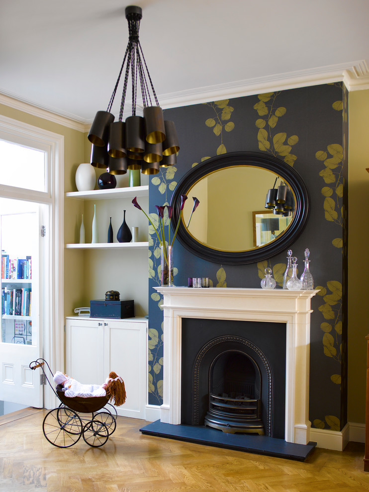 Photo of a large classic formal living room in London with light hardwood flooring, a standard fireplace, no tv and beige walls.